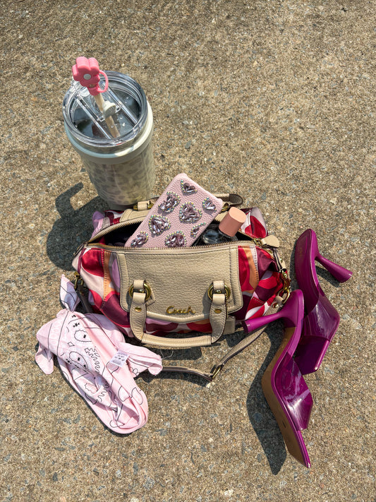 A bold and playful statement piece, this Coach Poppy Glam Tote features a glossy multicolor satin body in shades of chocolate, gold, and beige, accented with silver-tone hardware. The round “Coach Est. 1941” emblem gives it a signature touch, while the lightweight and roomy design makes it perfect for everyday wear.
